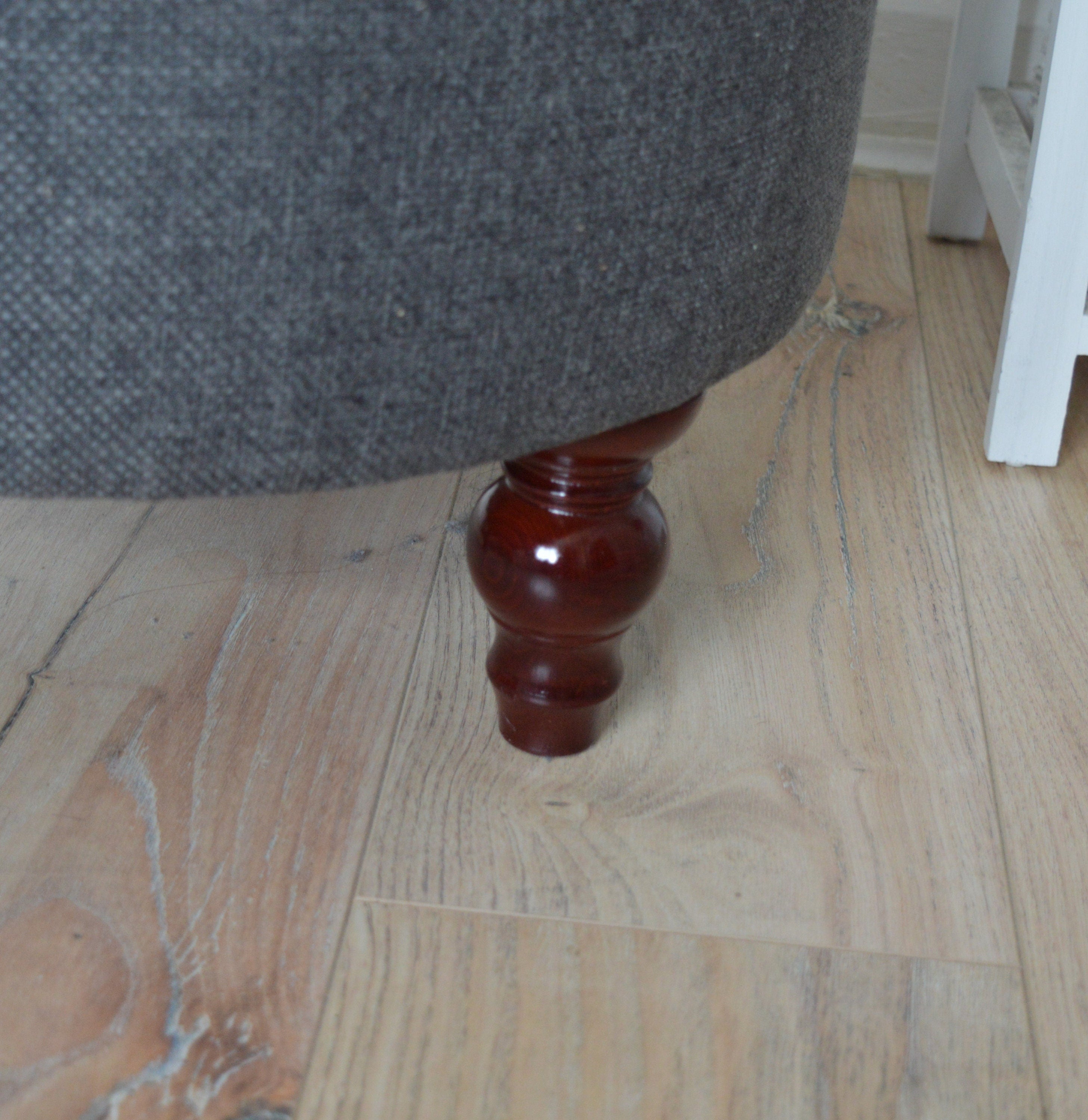 Circular round footstool upholstered in Warwick Rouen Charcoal Fabric With Turned Mahogany Hardwood  Legs