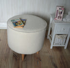Circular round footstool upholstered in Ivory Boucle Fabric With Natural Hardwood  Legs