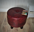 Circular round footstool upholstered in a premium wine faux leather with 4 cylinder Hard Wood Legs