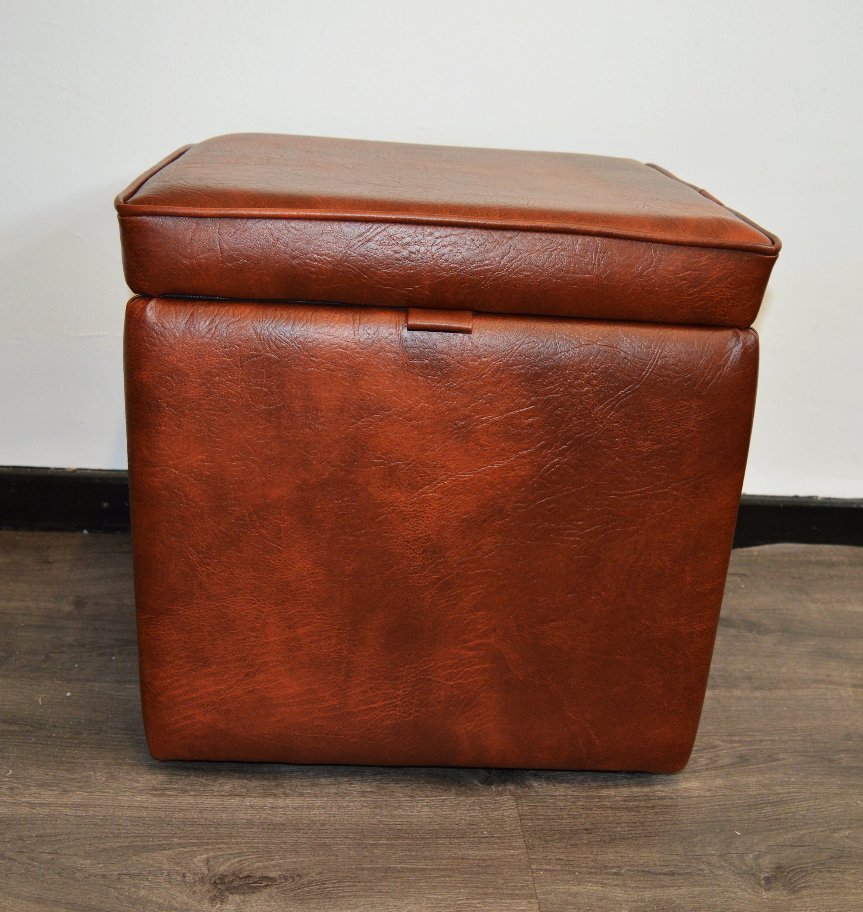 A Stylish  Cube Design footstool With Storage Ottoman footrest upholstered in a Premium Chestnut Faux Leather