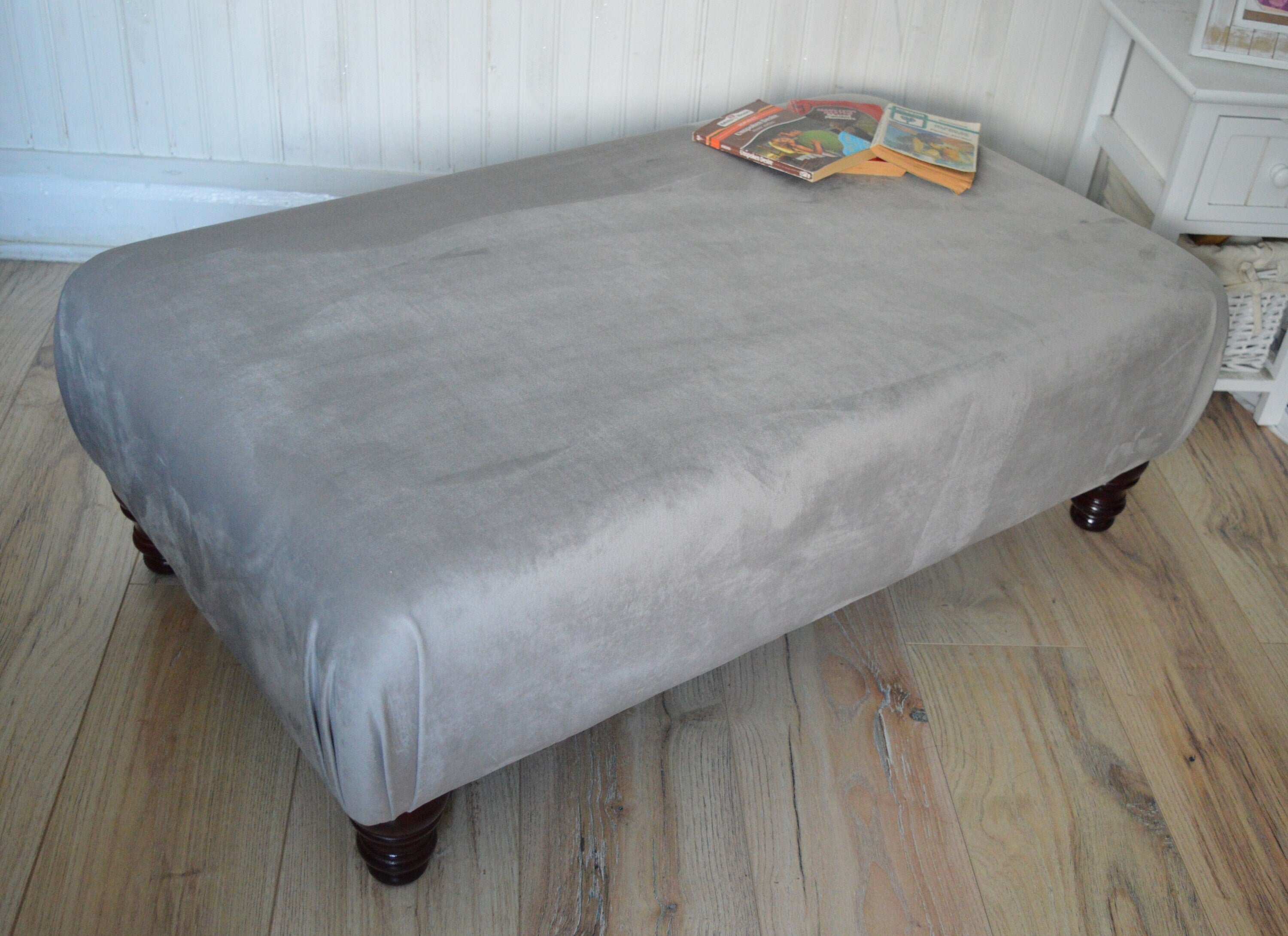 A Flat Top Footstool In Luxury Silver Velvet Fabric With Turned Mahogany Wood Legs