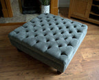 Square Chesterfield Style Deep Buttoned Footstool in Casino Dark Grey Fabric With Turned Hard Wood Legs