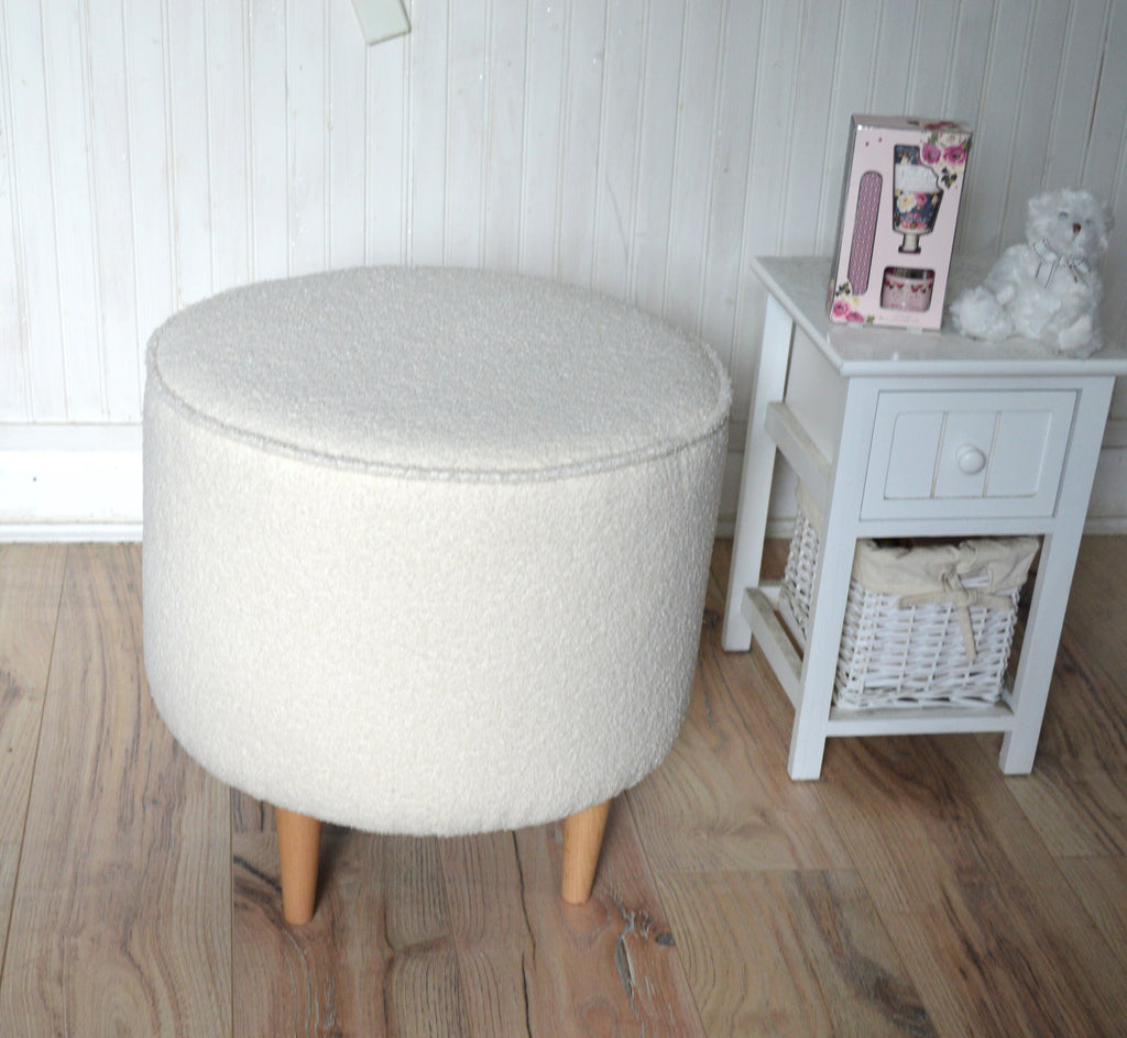 Circular round footstool upholstered in Ivory Boucle Fabric With Natural Hardwood  Legs