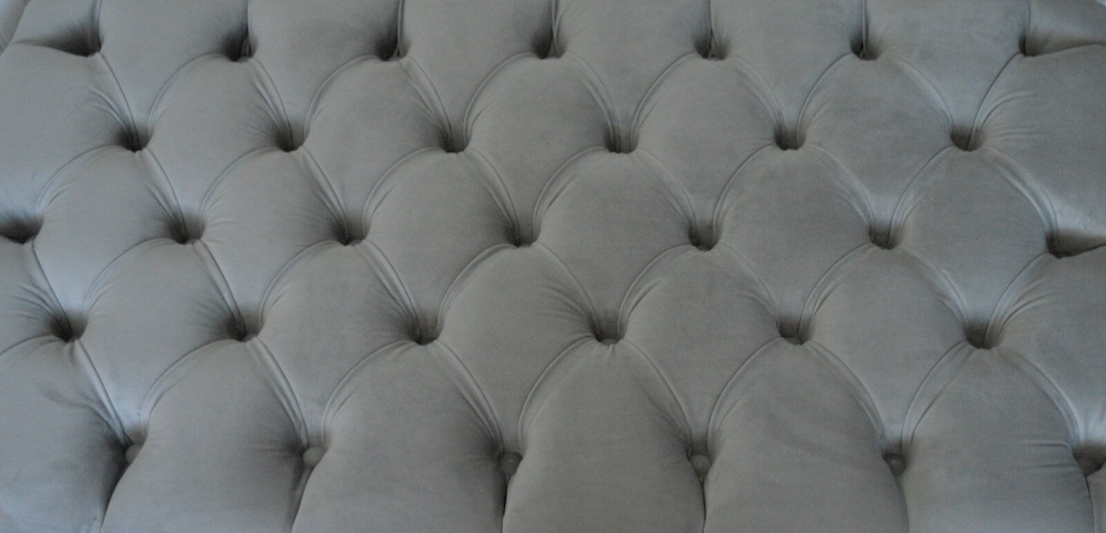Chesterfield Deep Buttoned Footstool in a Plush Silver Velvet With Mahogany Turned Hard Wood Legs
