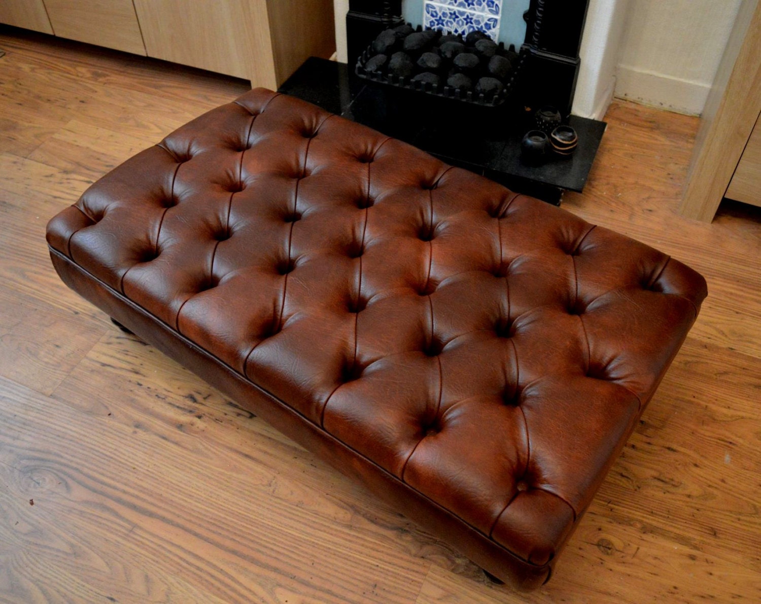 A Stylish UK Made Deep Buttoned Chesterfield Footstool in Premium Chestnut Faux Leather With Turned Hardwood Legs