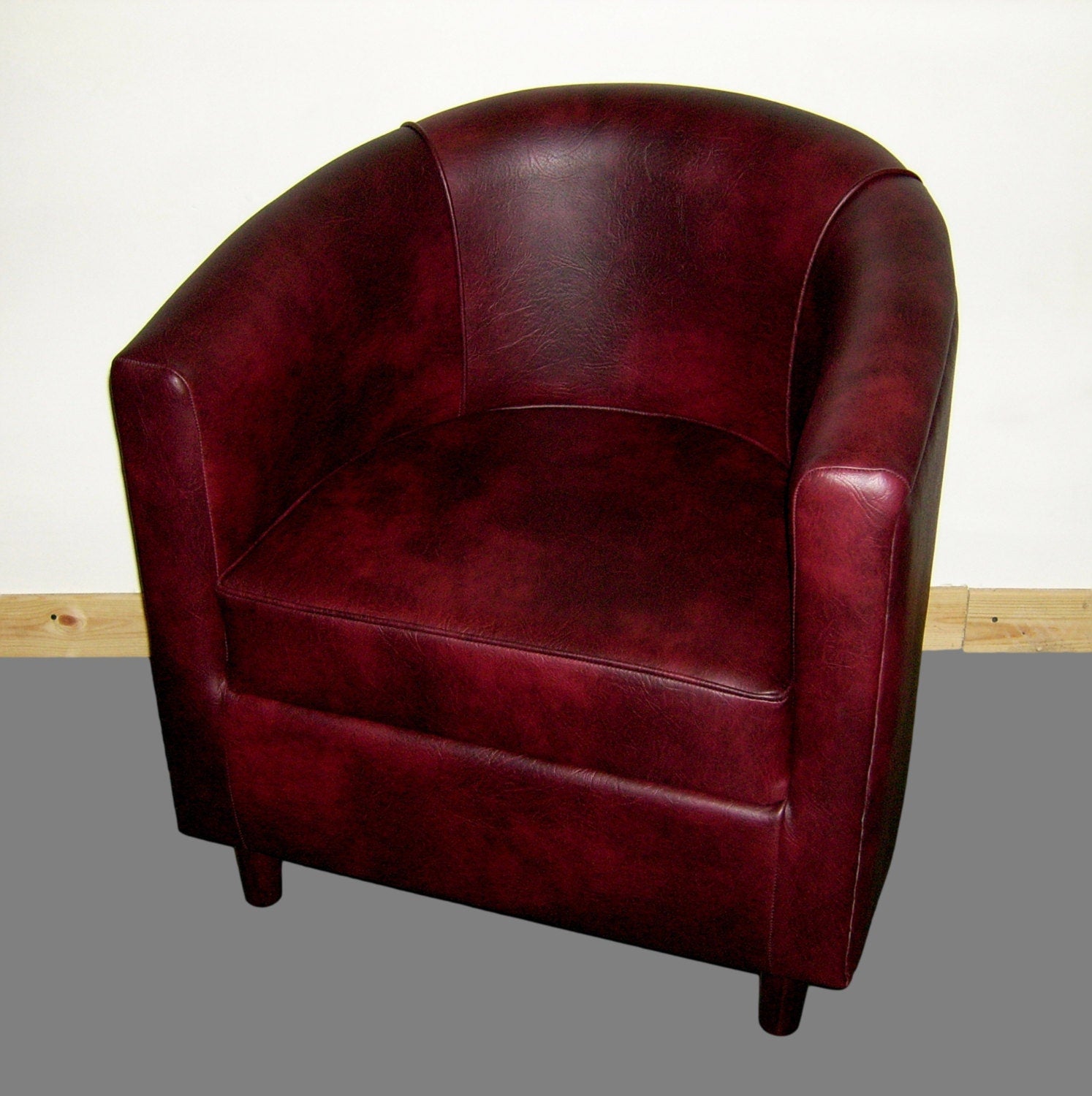 Tub Chair Upholstered In A Wine Faux Leather With Mahogany Wood Legs