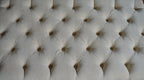 Chesterfield Deep Buttoned Footstool in Casino  Beige Fabric With Turned Mahogany Wood Legs