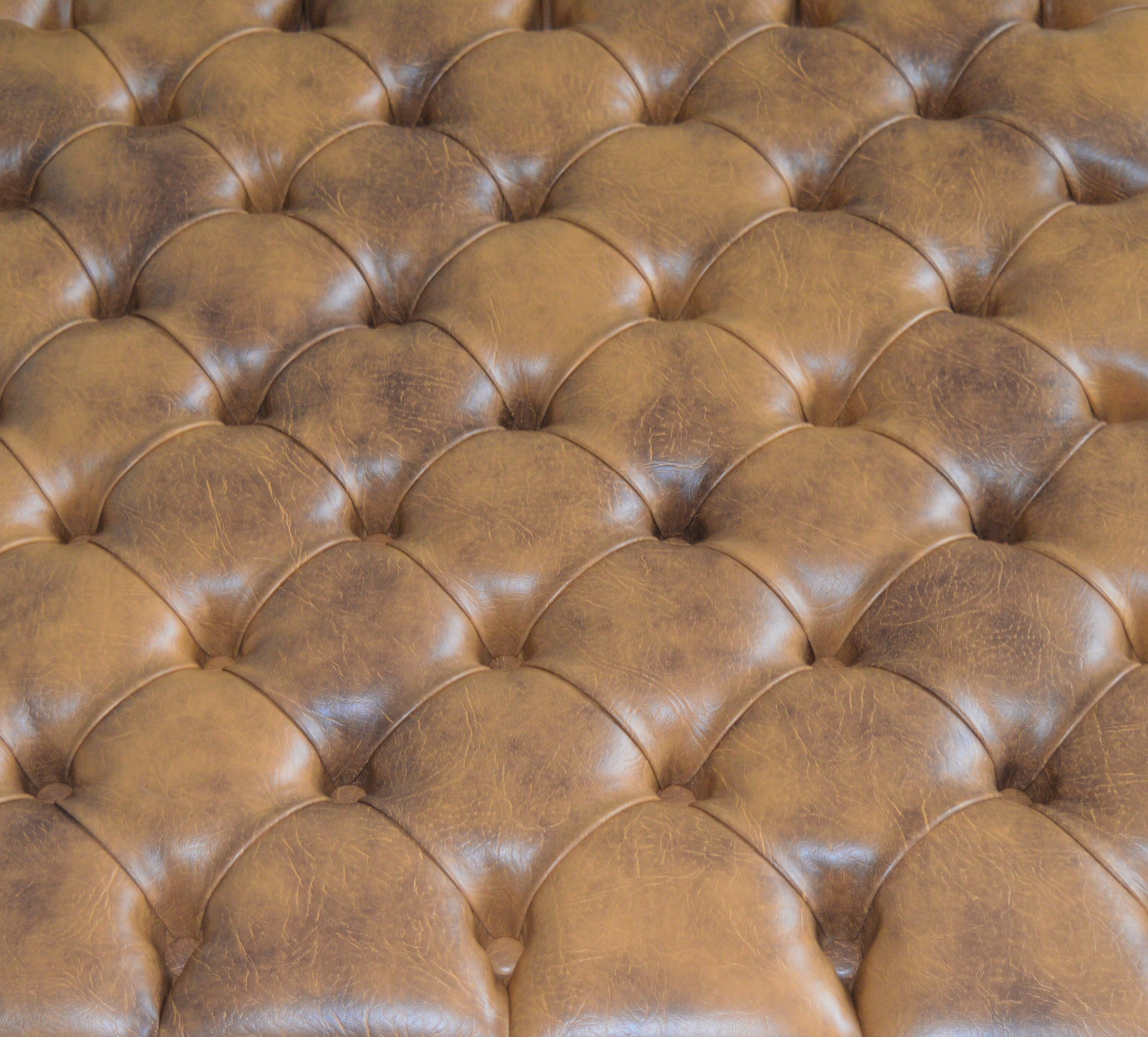 A Chesterfield Design Deep Buttoned Square Footstool in Premium Tan Faux Leather