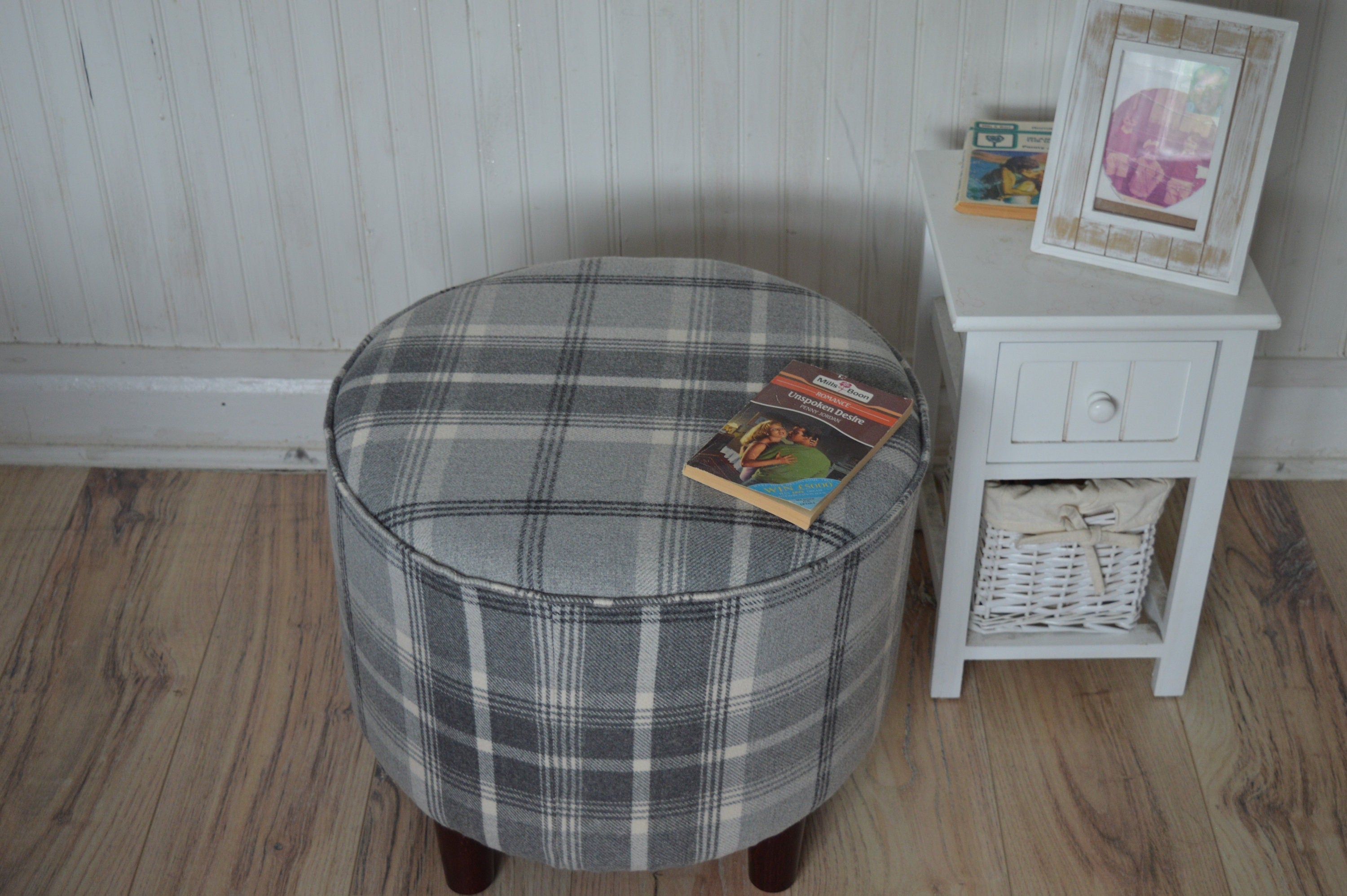 Circular round footstool upholstered in Balmoral Dove Grey Wool Effect Check Tartan Fabric With Turned Mahogany Hardwood  Legs