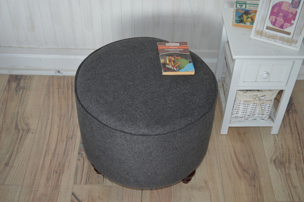 Circular round footstool upholstered in Warwick Rouen Charcoal Fabric With Turned Mahogany Hardwood  Legs