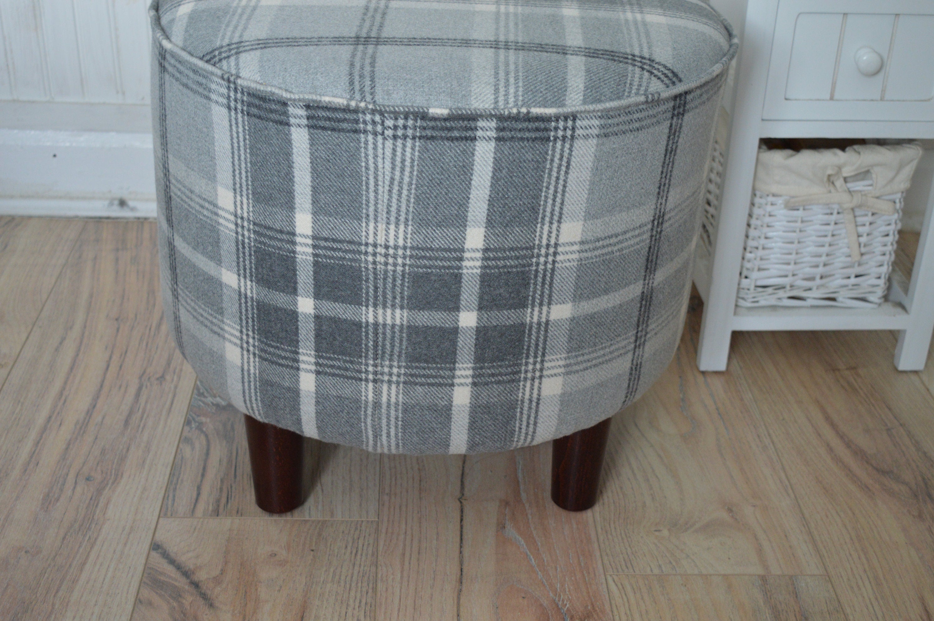 Circular round footstool upholstered in Balmoral Dove Grey Wool Effect Check Tartan Fabric With Turned Mahogany Hardwood  Legs