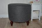 Circular round footstool upholstered in Warwick Rouen Charcoal Fabric With Turned Mahogany Hardwood  Legs