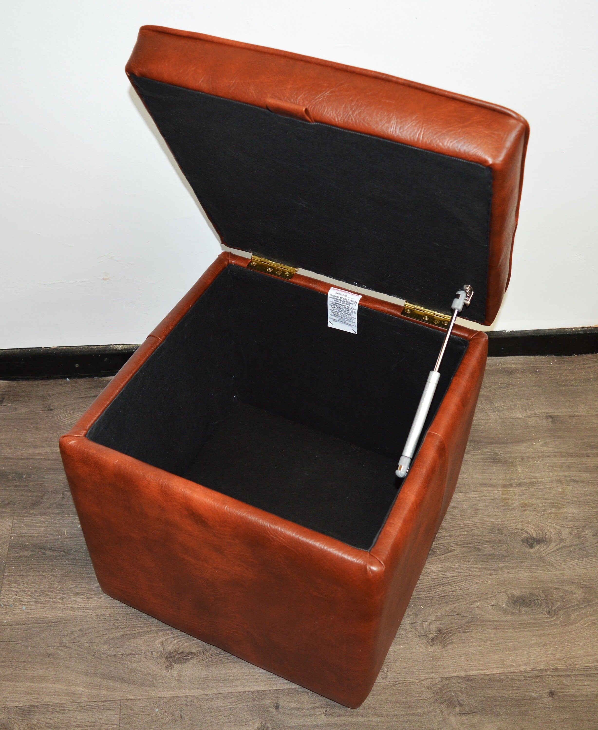 A Stylish  Cube Design footstool With Storage Ottoman footrest upholstered in a Premium Chestnut Faux Leather