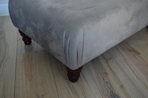 A Flat Top Footstool In Luxury Silver Velvet Fabric With Turned Mahogany Wood Legs
