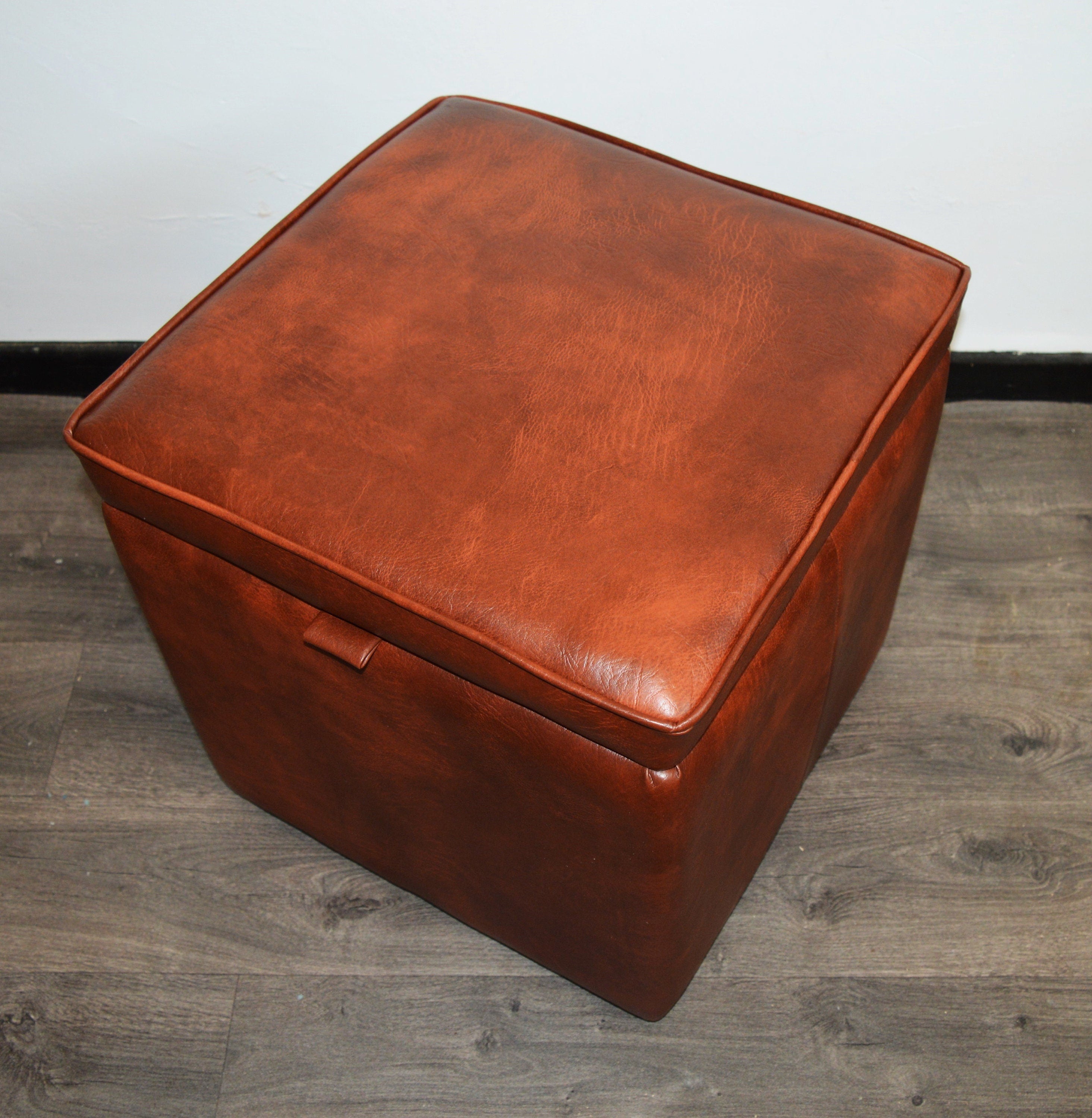 A Stylish  Cube Design footstool With Storage Ottoman footrest upholstered in a Premium Chestnut Faux Leather