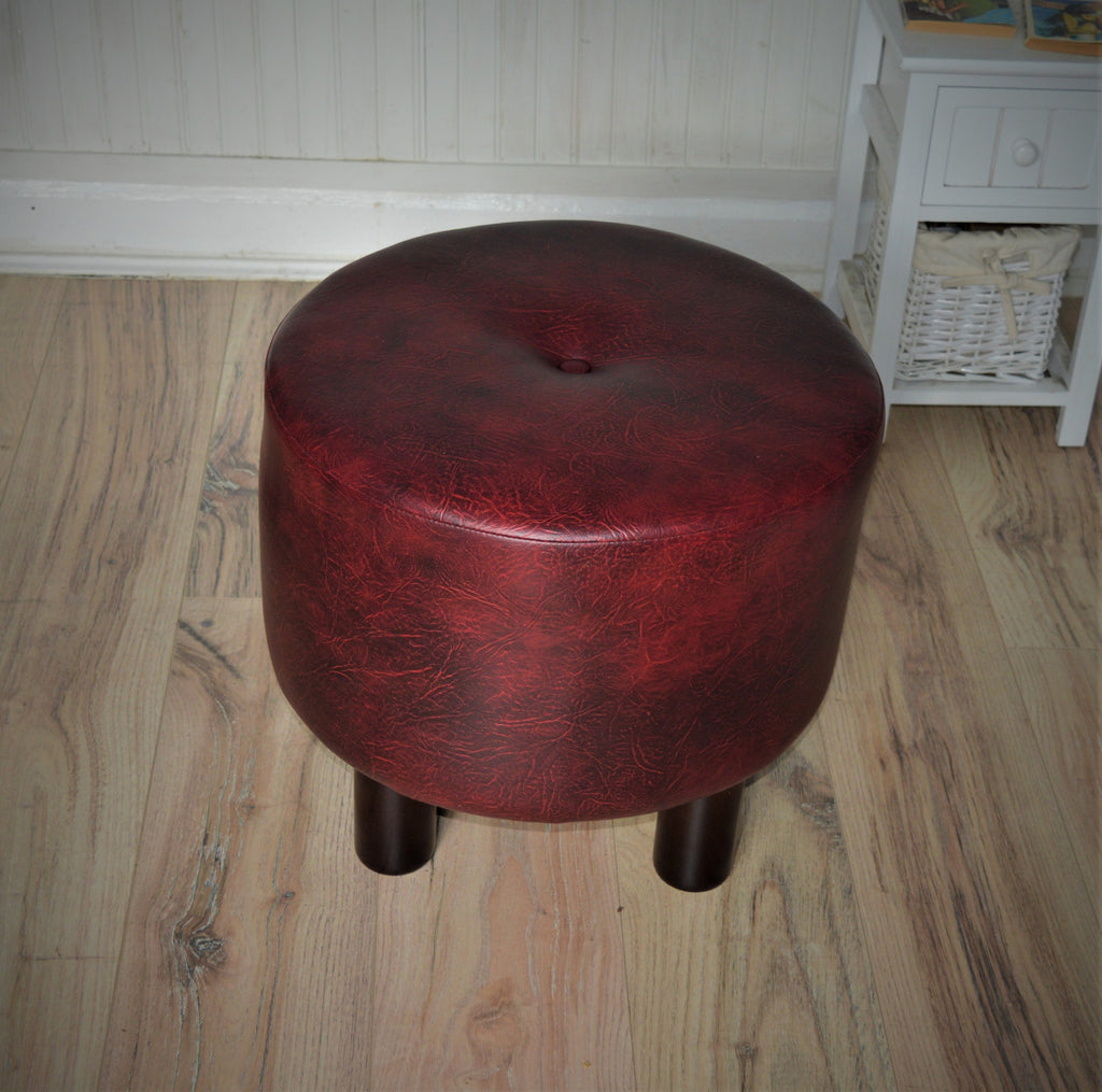 Circular round footstool upholstered in a premium wine faux leather with 4 cylinder Hard Wood Legs
