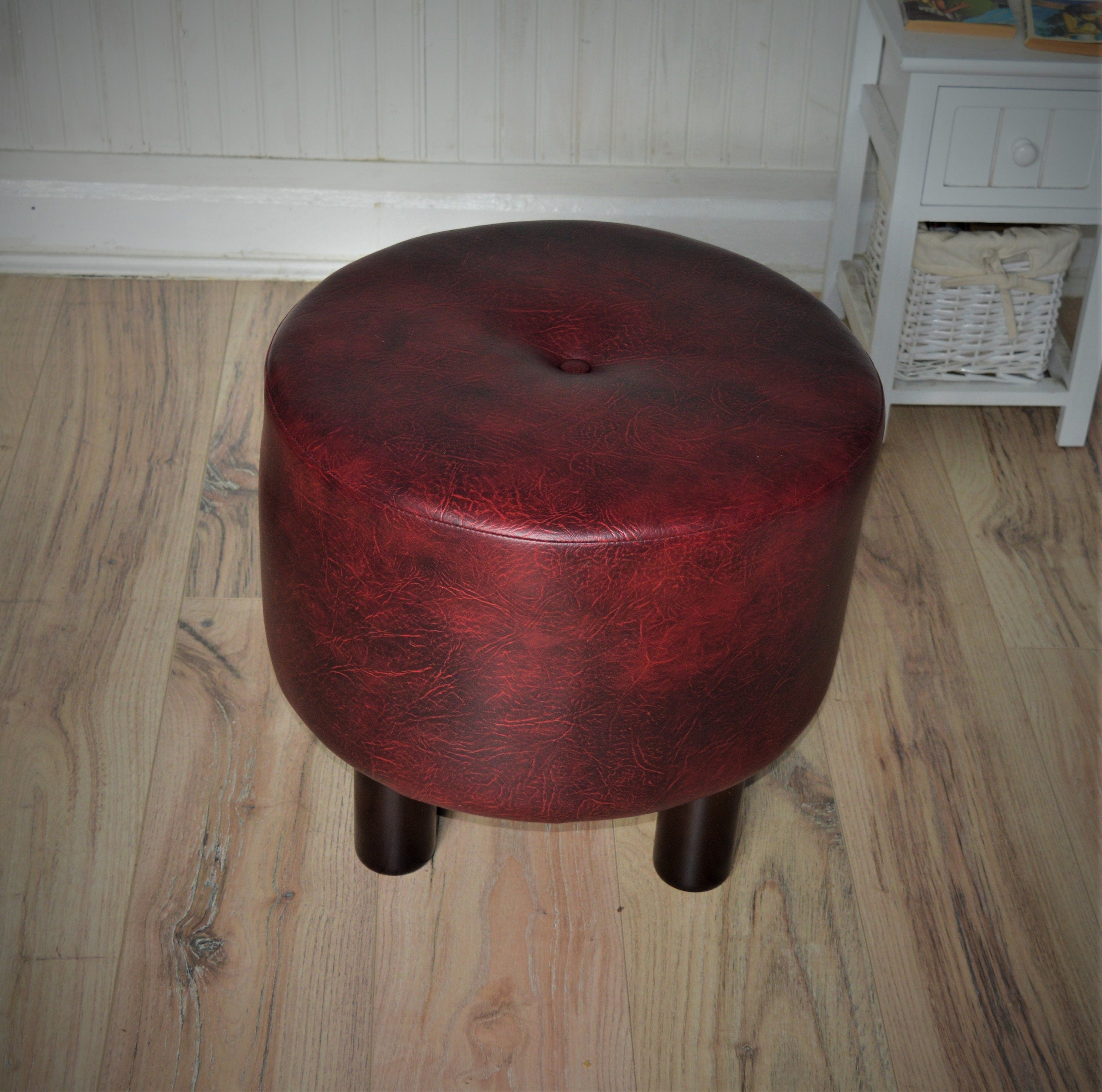 Circular round footstool upholstered in a premium wine faux leather with 4 cylinder Hard Wood Legs