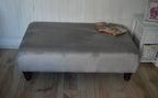 A Flat Top Footstool In Luxury Silver Velvet Fabric With Turned Mahogany Wood Legs