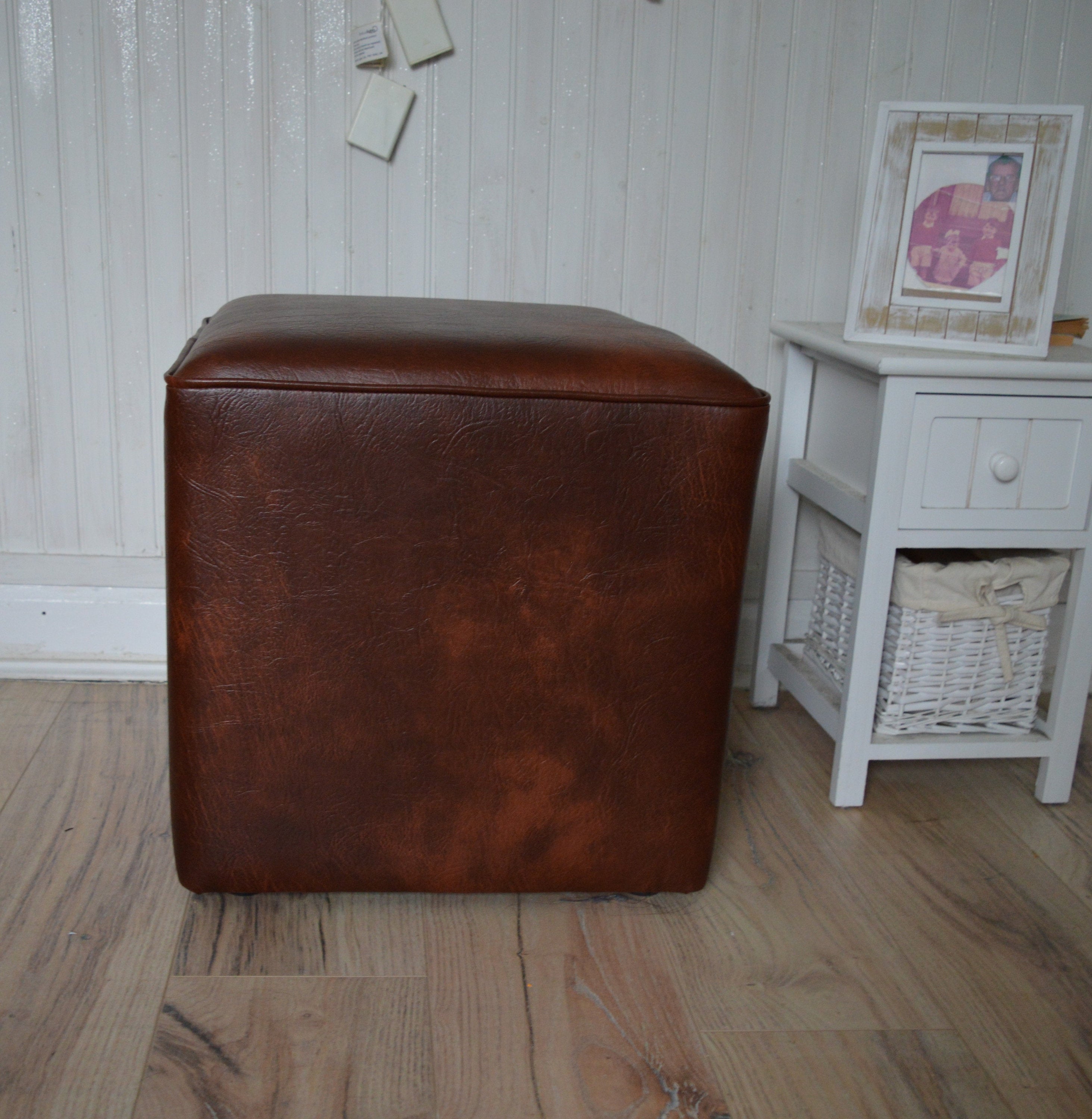 A Stylish  Cube Design footstool footrest upholstered in a Premium Chestnut Faux Leather