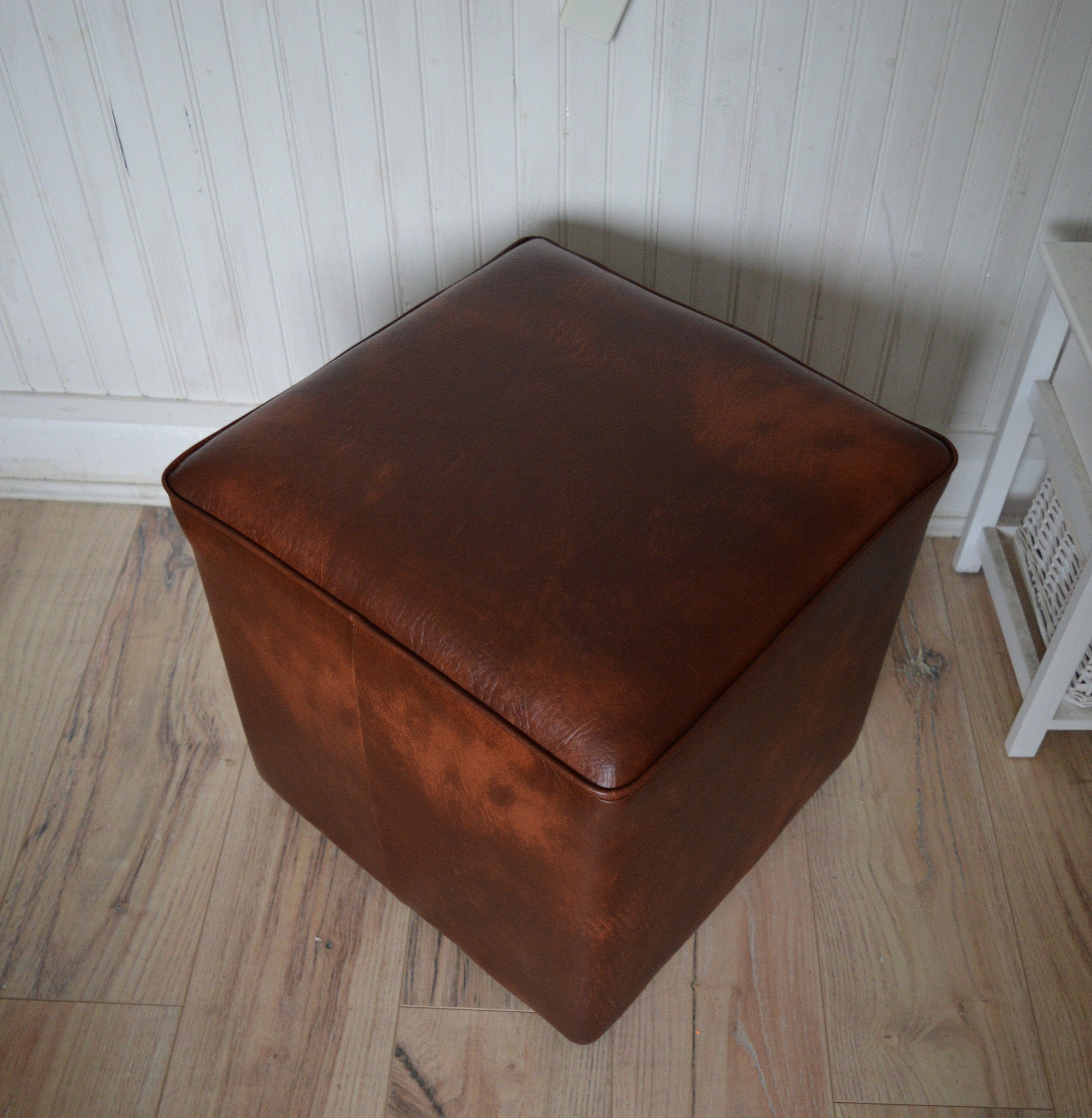 A Stylish  Cube Design footstool footrest upholstered in a Premium Chestnut Faux Leather
