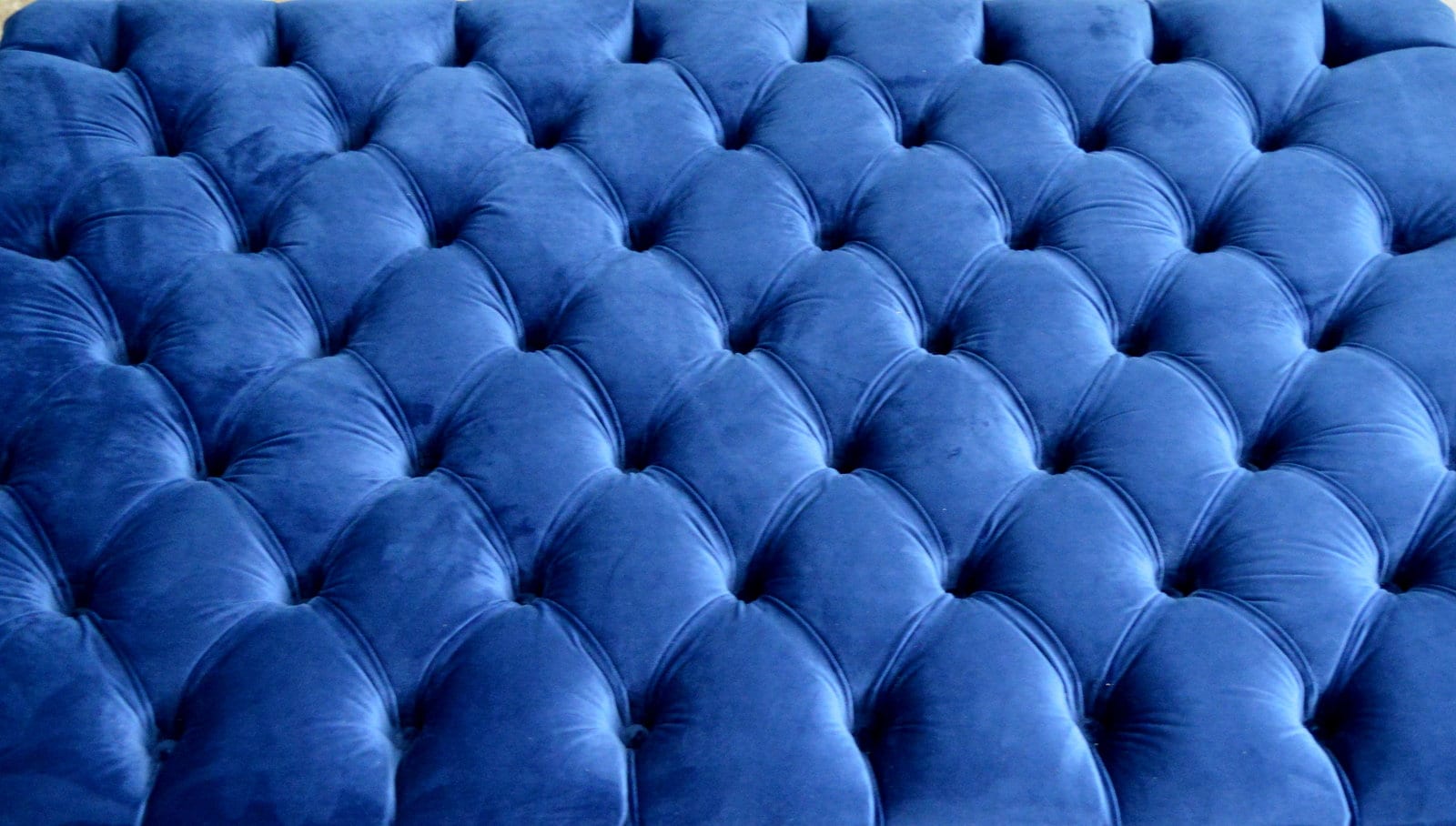 Chesterfield Extra Large Deep Buttoned Footstool in Royal Blue Velvet  With Turned Hardwood Legs