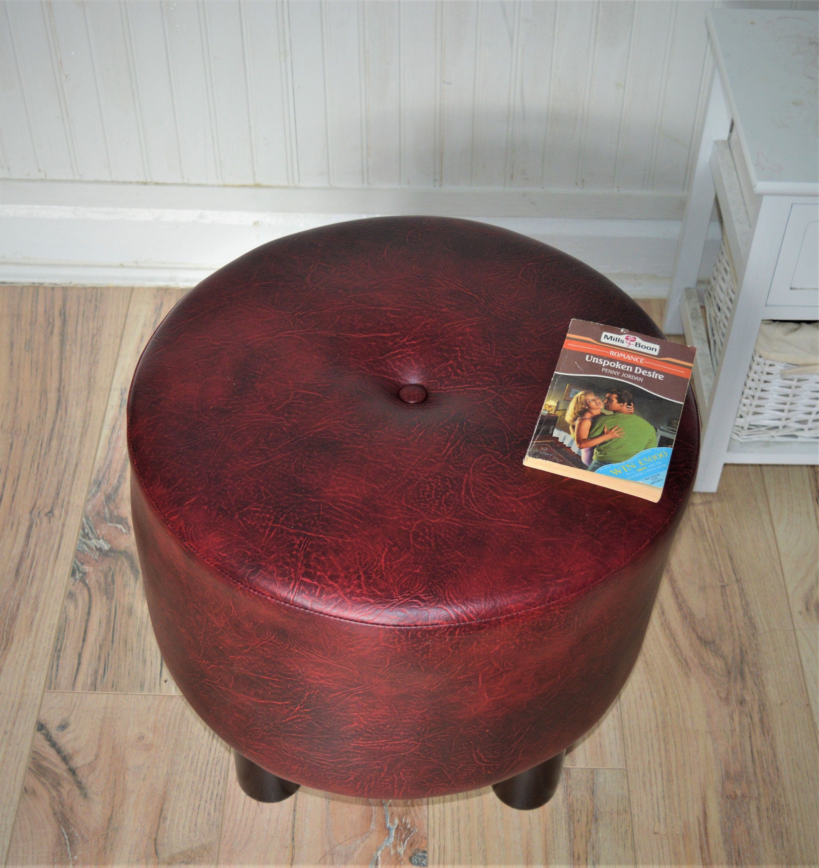 Circular round footstool upholstered in a premium wine faux leather with 4 cylinder Hard Wood Legs